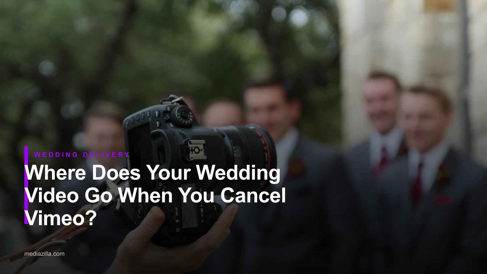 Wedding videographer in a suit holding a camera, for an article on wedding video delivery after cancelling Vimeo