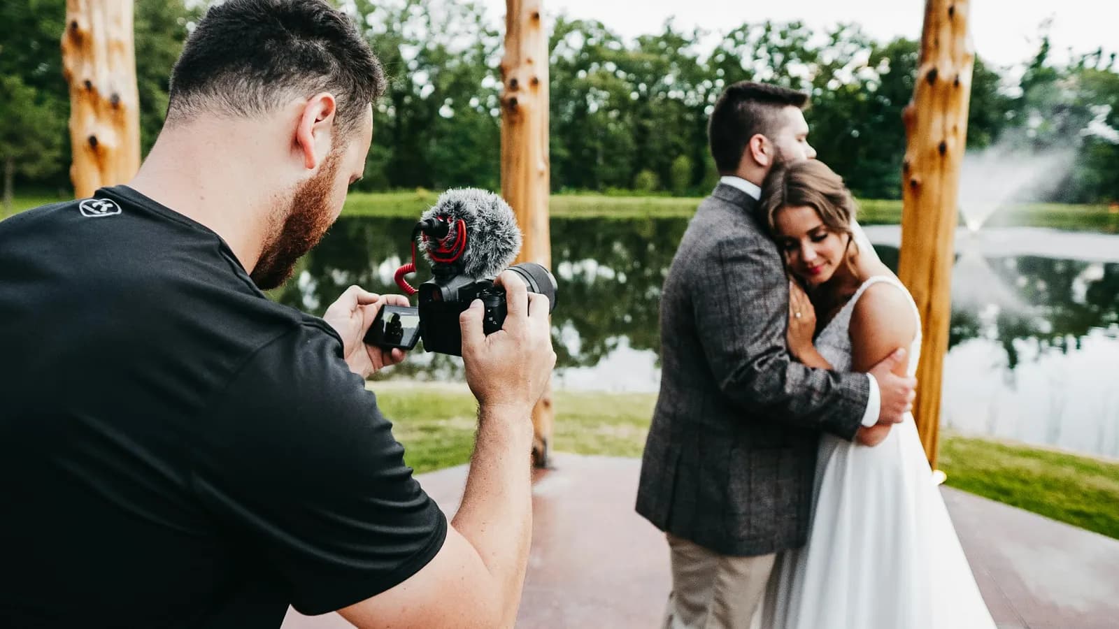 Wedding videographer holding a camera at an event